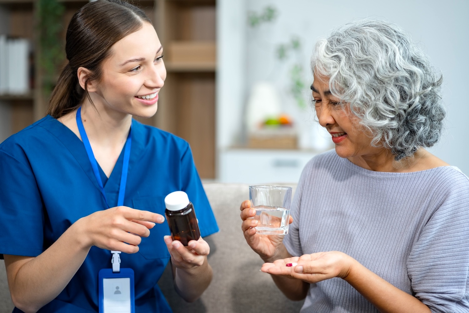 Young caregiver assisting elderly woman